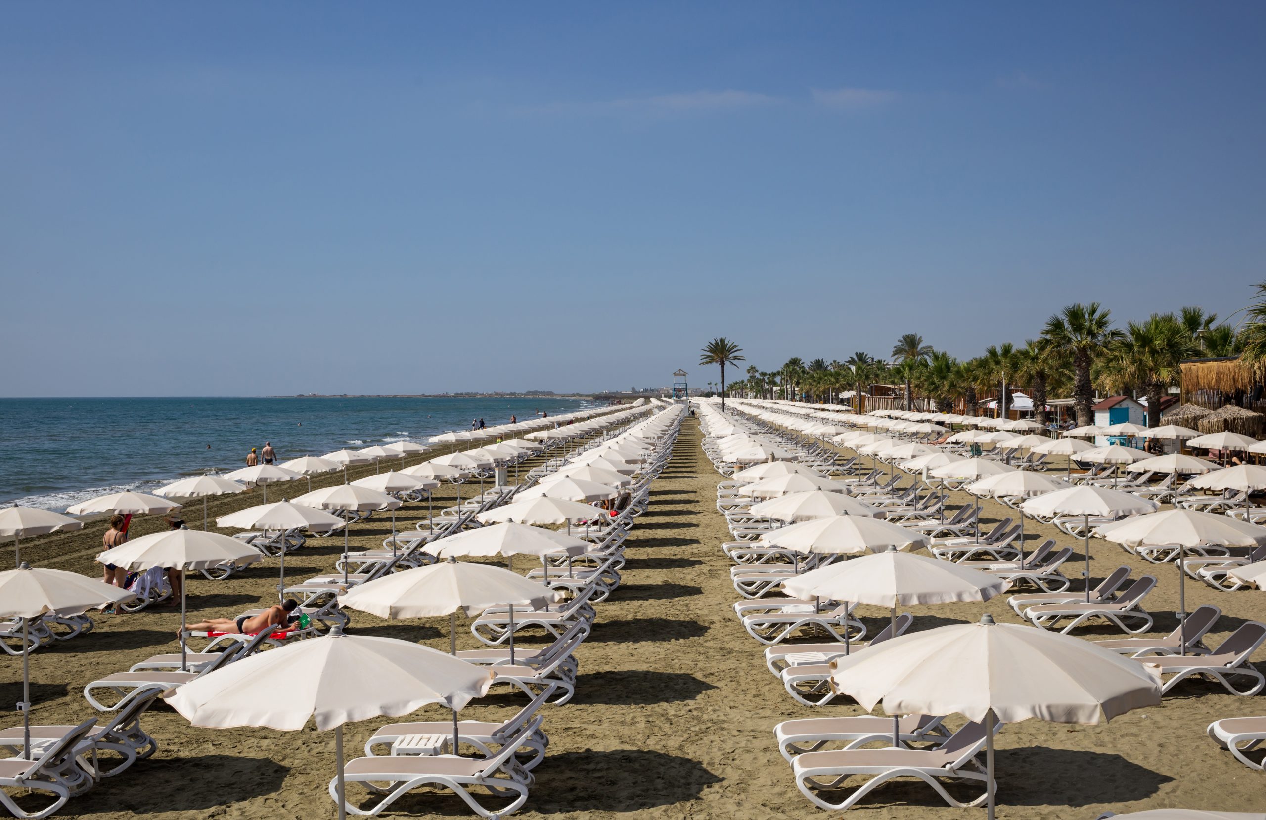 Mackenzie,Sandy,Beach,At,Larnaca,,Cyprus.,Sun,Loungers,And,Umbrellas